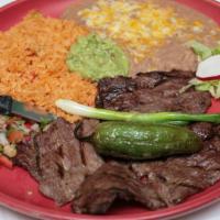 Carne Asada · Grilled thinly sliced skirt. Served with guacamole & two broiled green onions.
