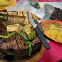 Molcajete · Delicious Carne Asada and Pollo Asado served with Camarónes al mojo de ajo, grilled green on...