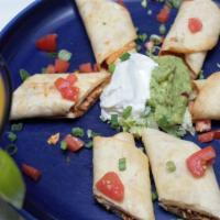 Chicken Taquitos · Crispy flour tortillas filled with chicken rolled and fried. Served with guacamole, sour cre...
