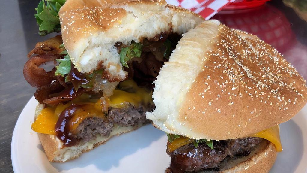 Hickory Burger (Regular) · BBQ sauce, bacon, onion rings, tomato, lettuce, cheddar.