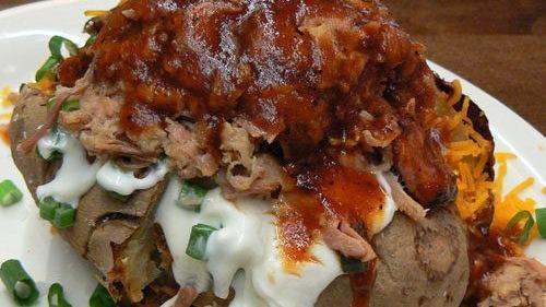 Loaded Bbq Potato · With butter, Cheddar cheese, sour cream and chives. Choice of meat: pulled pork, chunk chicken, bacon or brisket (for an additional charge).