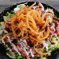 Tom'S Bbq Salad · Bed of lettuce, tomatoes, cucumbers, topped with ranch dressing, our famous mild BBQ sauce a...