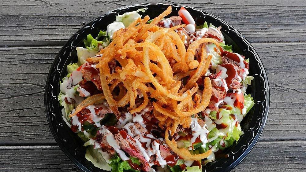 Tom'S Bbq Salad · Bed of lettuce, tomatoes, cucumbers, topped with ranch dressing, our famous mild BBQ sauce and onion strings with your choice of smoked chicken or pork, brisket (for an additional charge).