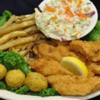 Fish Dinner · Hand-breaded flaky white fish fried to golden, served with hand-cut fries, coleslaw, hush pu...