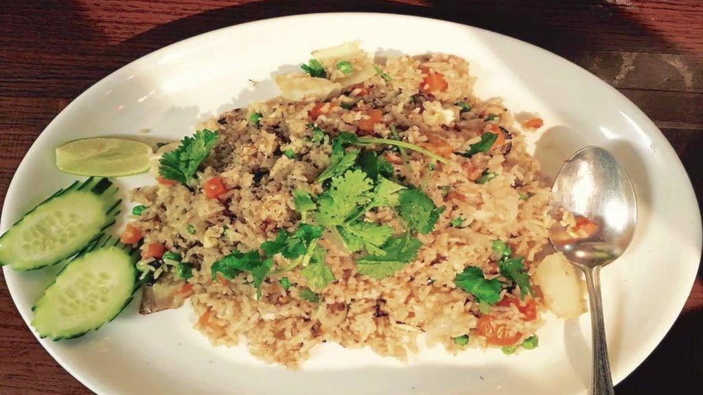 Fried Rice · Onions, tomatoes, peas, carrots, and egg topped with black pepper, cilantro, cucumber and tomato