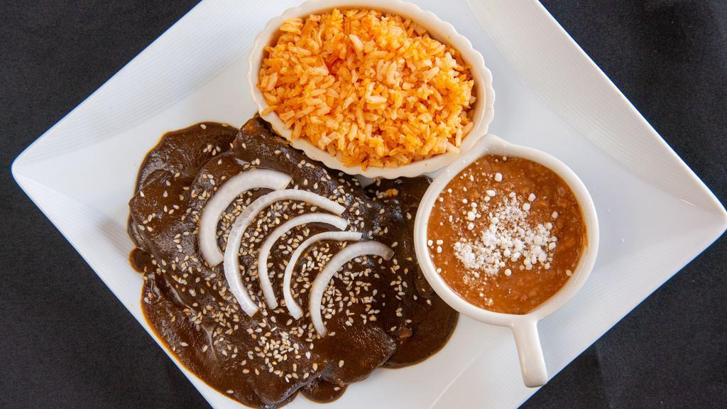 Enchiladas · (Don mole navarro, green or red sauce) chicken or asada, cheese, cream and onions served with rice and beans.