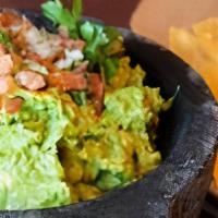 Tableside Guacamole · Fresh Hass avocados mixed with serrano chiles, garlic, tomatoes, onion, cilantro & fresh lim...