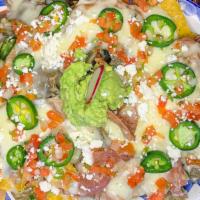 Vegan Nacho (Large) · House tortilla chips topped with vegan cheese, black beans, pico de gallo, vegan sour cream ...