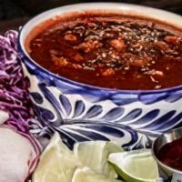 Pozole · Smoky Mexican stew made with pork & hominy, garnished with onion, cabbage, radish, avocado, ...