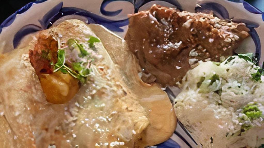 Shrimp Enchiladas · Oaxacan & Monterey jack cheese & wild shrimp wrapped in fresh corn tortillas, topped with chipotle cream sauce, sour cream, queso fresco & one of our famous bacon-wrapped imperial shrimp. Gluten-free. Served with cilantro rice & refried beans. Gluten friendly.