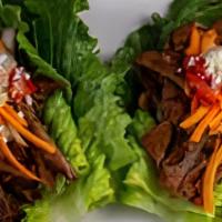 Lettuce Wrap Taco · Your choice of three tender marinated steak wraps or three grilled chicken wraps with fresh ...