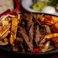 Shrimp & Steak Combo · Served over a bed of fresh-cut grilled peppers & onions on a sizzling skillet with fresh gua...