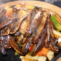Portobello Mushroom · Served over a bed of fresh-cut grilled peppers & onions on a sizzling skillet with fresh gua...