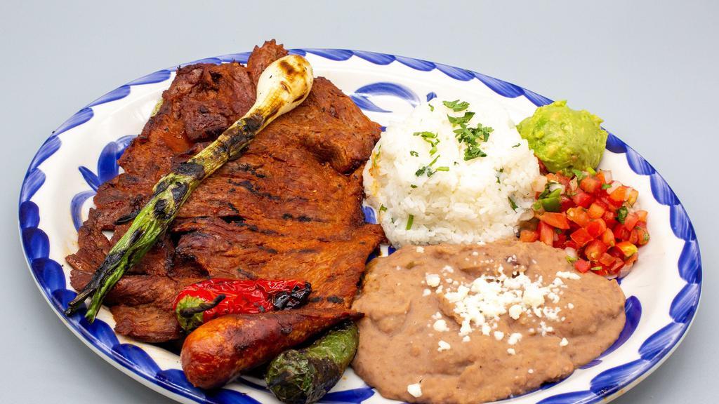 Carne Asada · Citrus-marinated grilled steak with chorizo, cactus, grilled chiles, onion, pico de gallo & fresh guacamole. Served with refried beans, cilantro rice & tortillas. (Chihuahua) Gluten friendly.