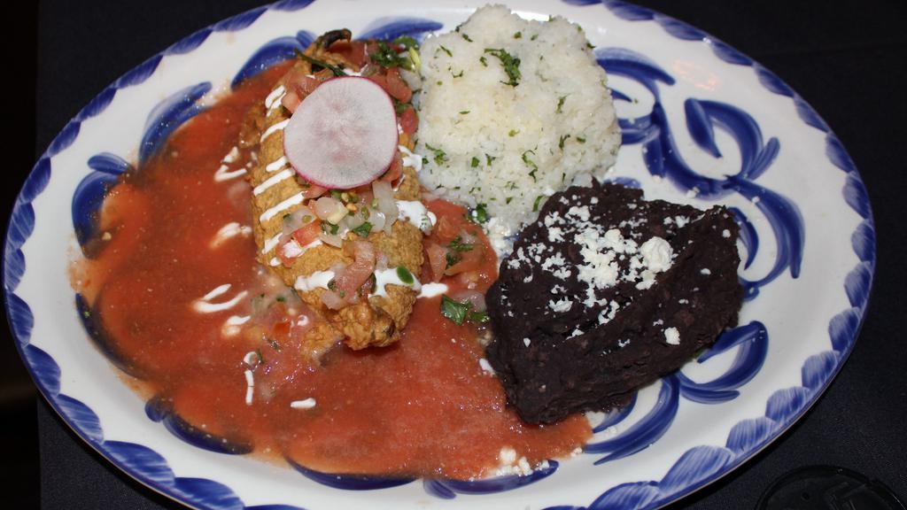 Chile Relleno · Roasted poblano pepper stuffed with Oaxacan & Monterey Jack cheese, lightly fried & topped with tomato sauce. Served with cilantro rice & black beans. Vegetarian.