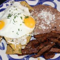 Chilaquiles · Fried egg, carne asada & fried corn tortillas with refried beans, onions, queso fresco, sour...