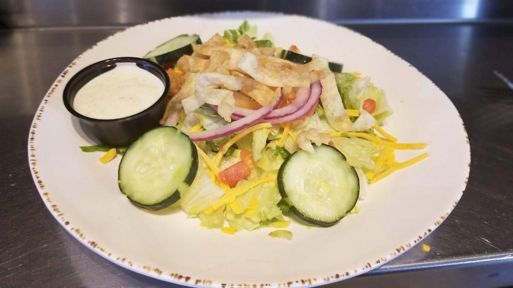 Side Salad · A blend of mixed greens, shredded cheddar cheese, cucumbers, red onions, tomatoes and crispy fried wontons served with your choice of salad dressing.