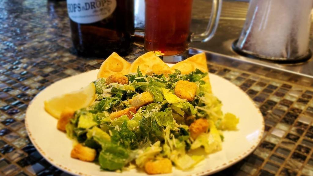 Caesar Full · The classic. Romaine lettuce, Parmesan cheese, and croutons. Served with Caesar dressing and a lemon wedge.