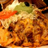 Nachos · Crisp corn tortilla chips topped with melted cheese, enchilada sauce, sour cream and guacamo...