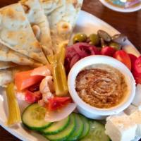 Hummus · Hummus and pita bread served with Feta cheese, marinated onions, pickled vegetables, cucumbe...