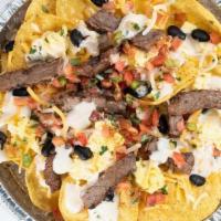 Nachos - Steak · Tortilla Chips, Scrambled Eggs, Black Beans, Shredded Cheese,Queso, Pico & Steak