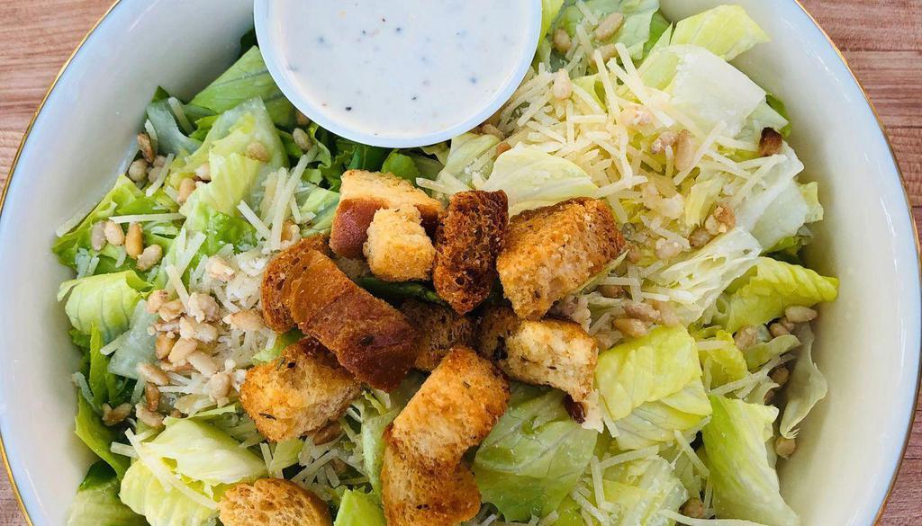 Caesar Salad · Fresh Romaine, Shredded Parmesan, Parmesan Crusted Pine Nuts, Croutons and Caesar Dressing served on the side