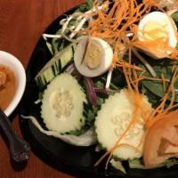 Thai Salad · Lettuce tomato, cucumber, onion, carrots, hard boiled egg, and topped with peanut sauce.