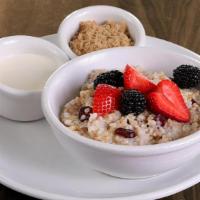 Organic Steel Cut Oatmeal · fresh fruit and dried cranberries served with a side of honey infused cream & brown sugar