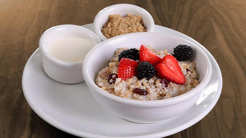Organic Steel Cut Oatmeal · fresh fruit and dried cranberries served with a side of honey infused cream & brown sugar