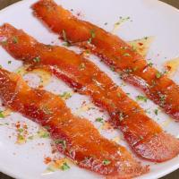 Millionaire'S Bacon · three slices of signature thick cut bacon served with honey, parsley & paprika