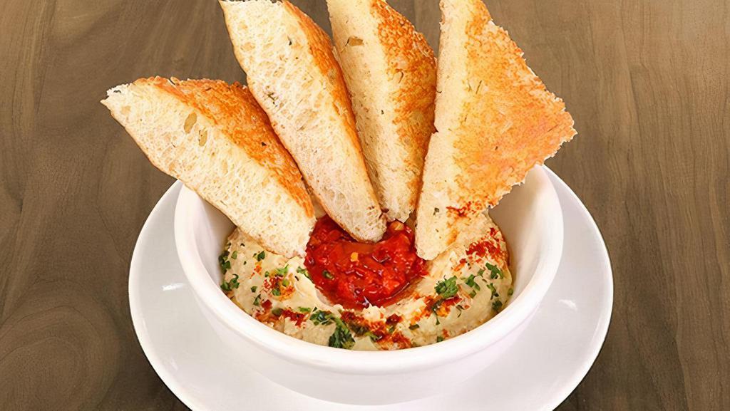 Classic Hummus · mama lil’s peppers, paprika & olive oil served with grilled herb focaccia