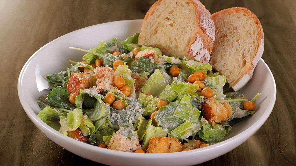 Kale-Romaine Caesar · organic baby kale, romaine, roasted chickpeas, parmesan, croutons & all-natural caesar dressing served with artisan bread