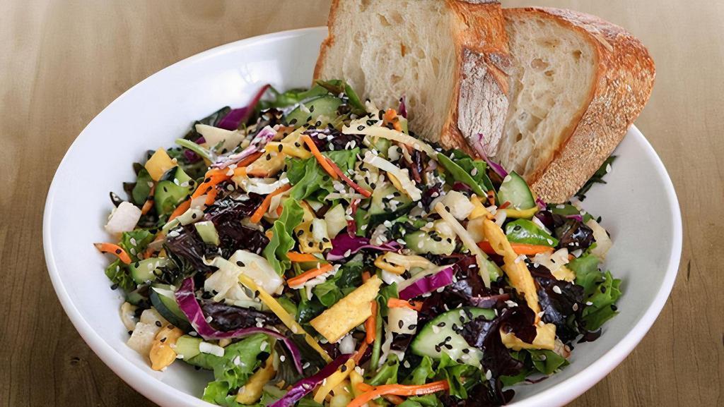 Asian Salad · organic field greens, green & red cabbage, cucumbers, organic carrots, celery, jicama, scallions, toasted sesame seeds, crispy noodles & all-natural thai peanut dressing served with artisan bread