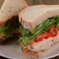 Turkey & Brie · all-natural turkey breast, brie, roasted red peppers, lettuce, tomatoes, grain mustard on so...