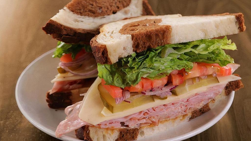 Honey-Cured Ham & Swiss · ham, swiss, red onions, tomatoes, dill pickles, lettuce, honey mustard on marble rye & served with a side