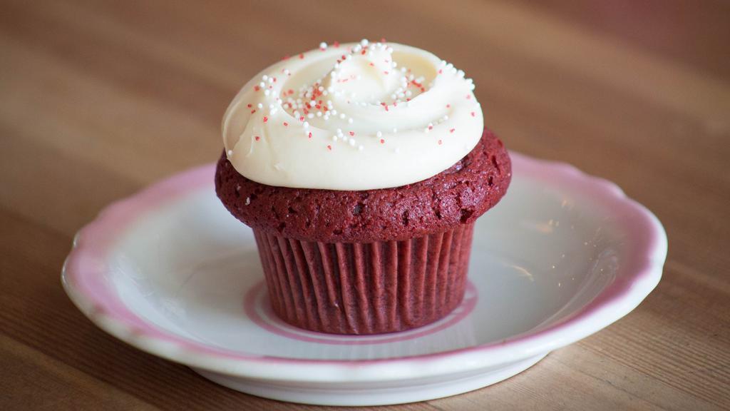 Red Velvet · A classic Southern buttermilk cake with a hint of cocoa. Topped off with a rich pile of cream cheese frosting and a dusting of red sparkle.