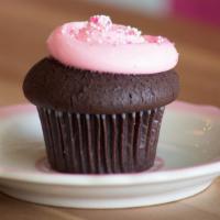 The Kate · Pink vanilla buttercream atop chocolate cake, sprinkled with fun pink and white sprinkles ma...