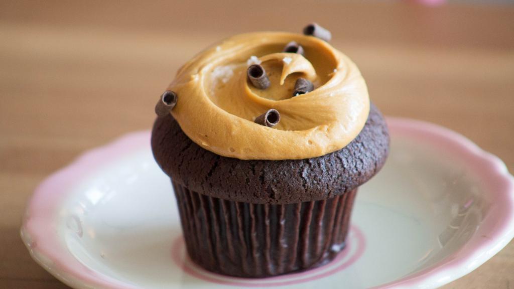 Salted Caramel · Chocolate cake royale topped with house made caramel buttercream, Fleur de Sel and dark chocolate curls.