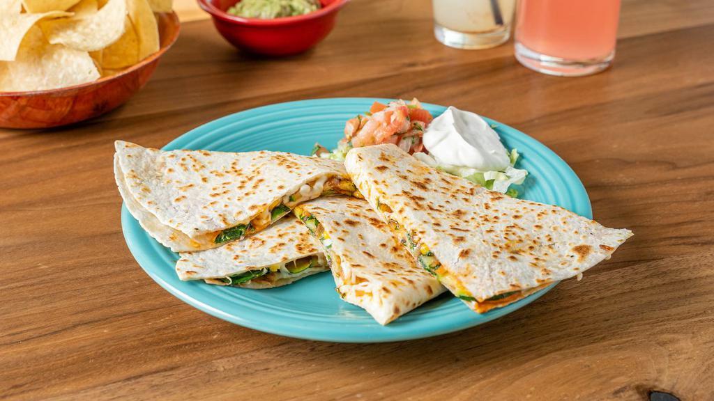 Carnitas Quesadilla · Braised pork meat served in a quesadilla with fresh cheese, refried beans, onions, and cilantro.