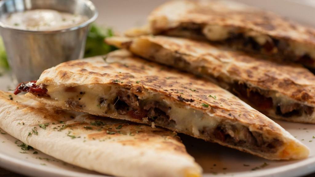 Lengua Quesadilla · Lengua (beef tongue) quesadilla with delicious melted cheese, refried beans, onions, and cilantro.