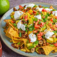 Pastor Nachos · Nachos decked with slowly cooked pork meat, delicious melted nacho cheese, sour cream, fresh...