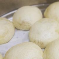 Steamed Buns · Hand rolled yeast bun filled with yummy goodness. This plate comes with two buns, our house ...