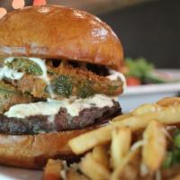 San Luis Peak · Green chili cream cheese, beer battered fried poblano peppers & cilantro lime crema on a bri...