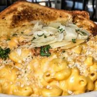 Mac-N-Cheese · Our signature cheese sauce, topped with Parmesan.