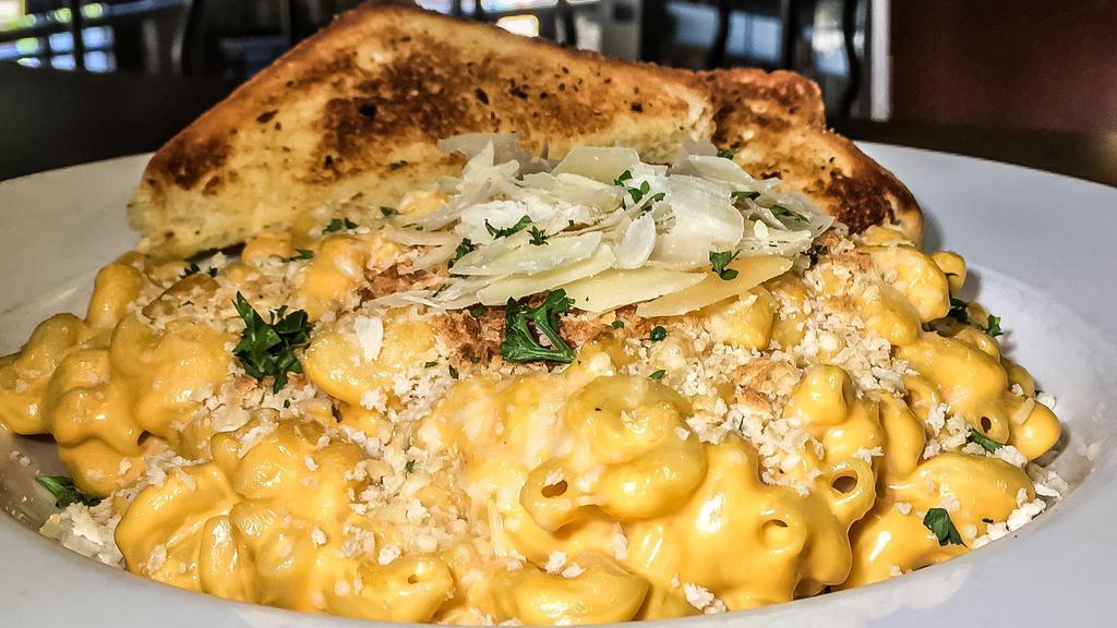 Mac-N-Cheese · Our signature cheese sauce topped with parmesan.