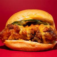 Nashville Hot Chicken Sandwich · An authentic dry hot chicken sandwich topped with pickles and our specialty farm sauce