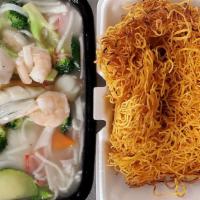 Seafood Pan-Fried Noodles · A nest of angel hair egg noodles pan-fried in a wok until golden brown and topped with mixed...