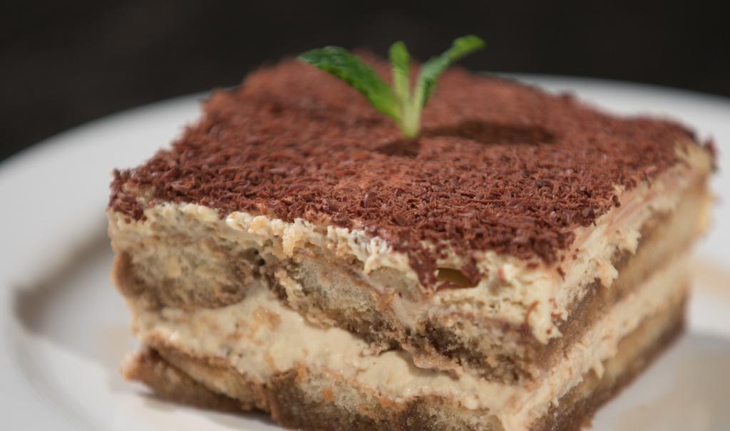 Tiramisu (Not Gluten Free) · Lady fingers soaked with marsala and our cold brew house roasted espresso, with mascarpone cream and chocolate shavings. Not gluten free.