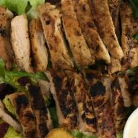 Grilled Chicken Caesar Salad · Sliced grilled chicken breast on a bed of romaine lettuce, craisins & parmesan cheese and cr...