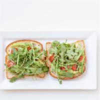 Garden Avocado Toast · Two slices of GF mulitgrain bread with smashed avocado, grape tomatoes, and arugula. Comes w...